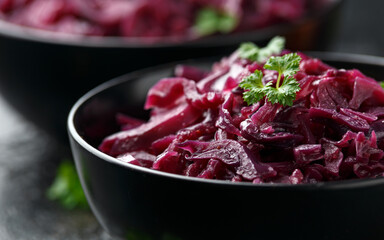 Braised Red Cabbage with apples and redcurrant in black bowl