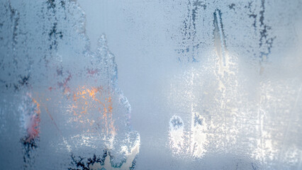 Ice frost on the window, side view. Hoarfrost froze on the window in a bizarre way. Abstraction of hoarfrost on a winter window.