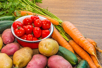 Autumn collection of vegetables. Vegetables with a garden patch on a wooden background.