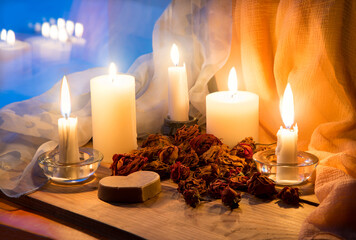 Candles and dried rosebuds on the table