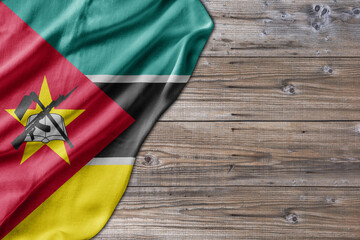 Wooden pattern old nature table board with Mozambique flag - 485400765