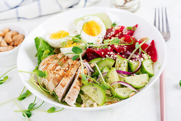 Healthy breakfast. Boiled eggs salad with greens, cucumbers, beetroot and grilled chicken fillet and red onion. Lunch.