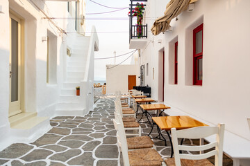 Obraz na płótnie Canvas Paros island Naousa Greece. Building cobblestone alley outdoor cafe tavern summer day.