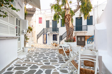 Paros island Naousa Greece. Building cobblestone street outdoor cafe tavern summer day.