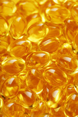 Golden Vitamin D3 Capsules close-up in full screen