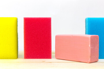 Colorful sponges and soap on a white background.