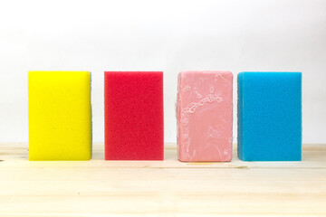 Colorful sponges and soap on a white background.