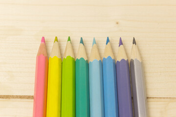 Color pencils on a wooden background