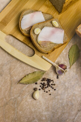 Bread with bacon and garlic on a wooden board.