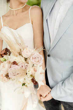 wedding bouquet on the background of a wedding couple. images of the bride and groom. wedding concept
