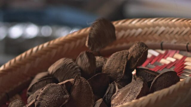 Dumping a bowl of fresh Brazil nuts organically harvested from the Amazon rainforest into a basket