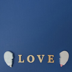 A heart that burst from the word LOVE in the middle on a blue background. Flat lay minimal scene.