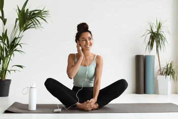 Beautiful Young Athletic Woman In Earphones Listening Music On Smartphone While Training