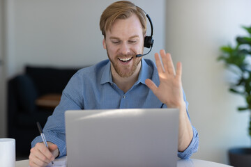 Caucasian man at home remote working at home on laptop computer talking to a colleague