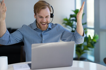 Caucasian man at home remote working on laptop computer talking with his colleague