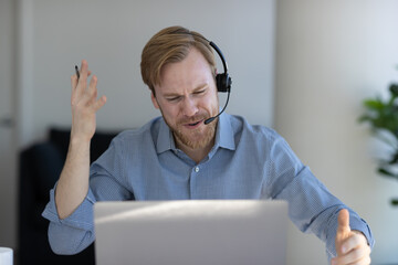 Caucasian man at home remote working on laptop computer talking with his colleague