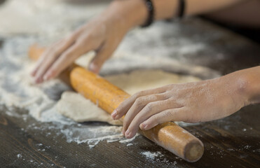 children's hands make dough on the table close-up.