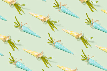 Colorful decorative carrots pattern on a pastel green background. Spring colors, Easter minimal template.