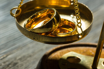 Divorce and separation concept. Two golden wedding rings, judge gavel.