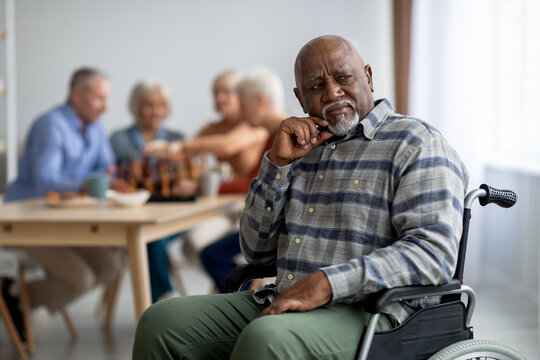 Disabled african american senior man in wheelchair feeling lonely