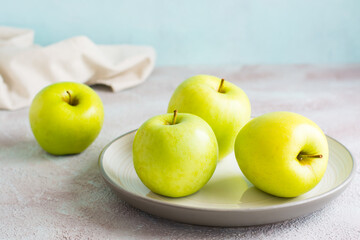 Fresh green apples on a plate on the table. Detox diet. Lifestyle