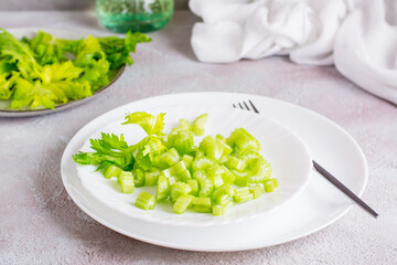 Dietary salad of fresh chopped celery on plates on the table. Vegetarian food