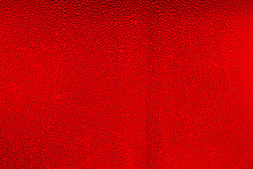 Water droplets on the glass with a red illumination 