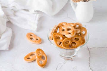 Bavarian pretzels in a glass bowl on the table. Snack for fast food. Close-up