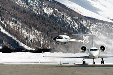 Helicopter landing at Engadine St Moritz airport in winter