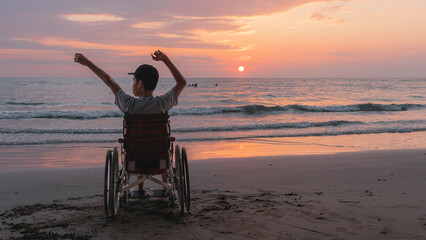 Behind of young man with disability looking sunset on the sea beach at summer, Positive photos give life energy and power concept.