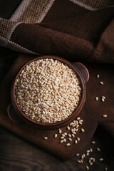 Bowl of raw dried broken pearl barley cereal grain