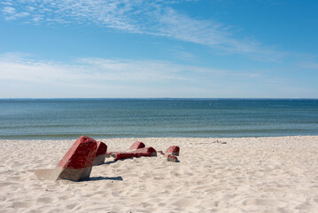 Pieces of old concrete breakwater on the beach by the Baltic Sea. Hel, Poland. 