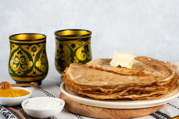Shrovetide Maslenitsa festival. Russian pancakes blini. Pancakes with honey and jam. Russian spoons. National russian festival. Russian crepes.