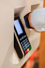 man use smart bracelet to make contactless payment over nfc technology, apply to payment terminal