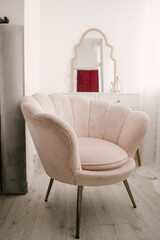 Women's bedroom interior, soft pink stylish armchair in the shape of a shell