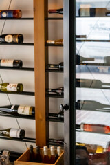 Defocused view of wine storage room with open glass door