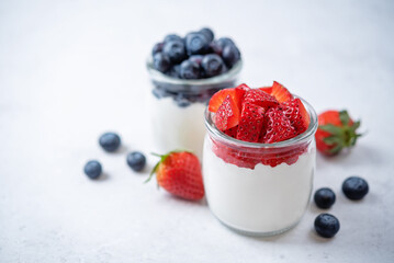 Greek yogurt strawberry blueberry parfait in jars