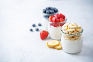 Set of Greek yogurt strawberry blueberry banana parfait in jars