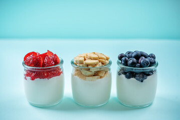 Set of Greek yogurt strawberry blueberry banana parfait in jars
