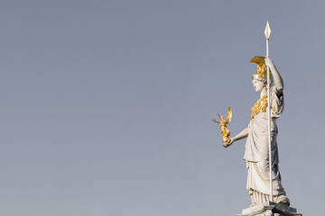 The statue of Pallas Athena on gray background with copy space for your design near Parliament building in Vienna, Austria
