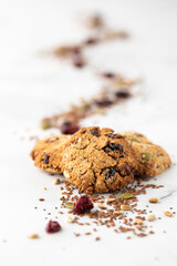 Homemade Ketogenic trail mix cookies with a trail of the mix in behind.
