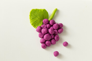 Making grape game step by step with dough for children's activity in the school art lesson and plasticine concept.