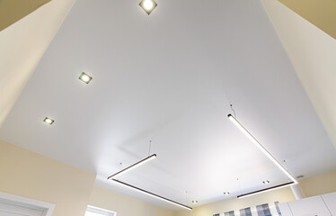 Modern white matte stretch ceiling with zoned lighting