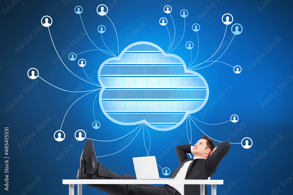 Aufkleber Attractive businessman relaxing or daydreaming at table with laptop and abstract cloud computing hologram on blurry blue background. Technology, database, communication and connection concept. 
