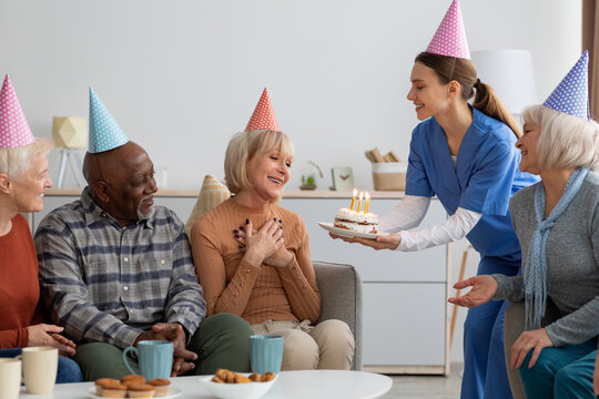 Elderly woman having birthday party at nursing home