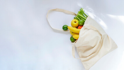 Reusable shopping bag full of fruits and vegetables. Zero waste, sustainable living concept