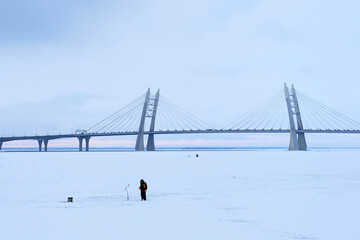 Winter fishing. View of the Cable stayed bridge of Western high speed diameter, Saint Petersburg,...