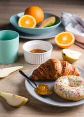 Healthy breakfast. Croissant, donut, coffee, jam, fruits: oranges and pears.
