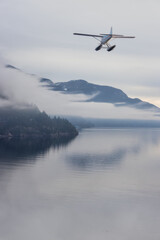 Fototapeta na wymiar Seaplane flying over Canadian Mountain Nature Landscape on the Pacific West Coast. Cloudy and fog Winter Day. 3d Rendering Airplane Adventure Concept. Howe Sound, British Columbia, Canada.