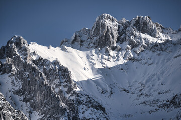 Karwendel - winter landscape with snow covered mountains, rocks and blue sky